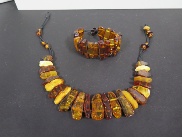 A Baltic amber necklace and bracelet of slab cut polished amber, largest piece 27x12mm, total weight