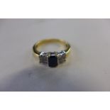 An 18ct hallmarked yellow gold sapphire and diamond ring, the central sapphire approx 6x4x1.5mm -