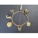A 9ct yellow gold curb link bracelet with padlock fastening and safety chain, hallmark to each
