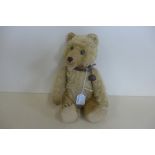 A Steiff 'Teddy Baby' bear, with collar and bell 1948 - blank button in ear, 25cm tall, plush fur,