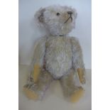 A mid 20th century or earlier Yes-No bear, 52cm tall, glass eyes and felt pads, tail moves, head