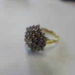 An 18ct yellow gold diamond cluster ring, size O, approx 7.1 grams - in generally good condition