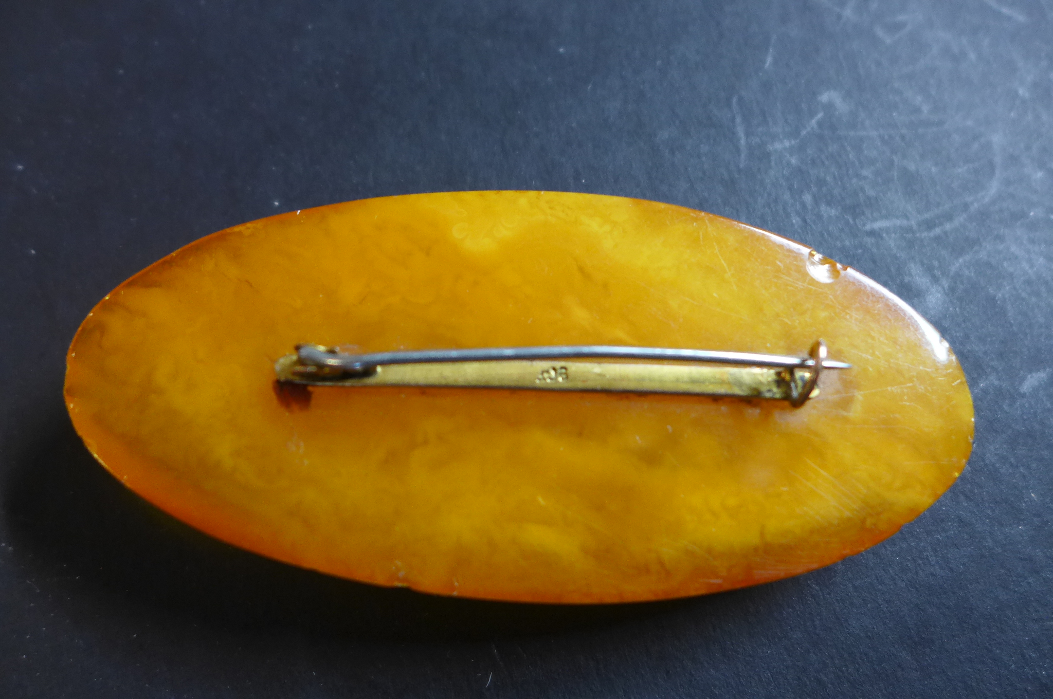 A large polished amber brooch, with 9ct fitting and steel pin, width 8cm, height 3.6cm, weight - Image 2 of 2