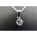 An 18ct white gold diamond pendant, the diamond measuring 0.4ct approx, presented on a silver