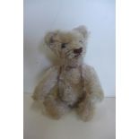 A miniature mohair bear circa 1920'30's, 15cm tall, no button but hole to left ear, probably Steiff,