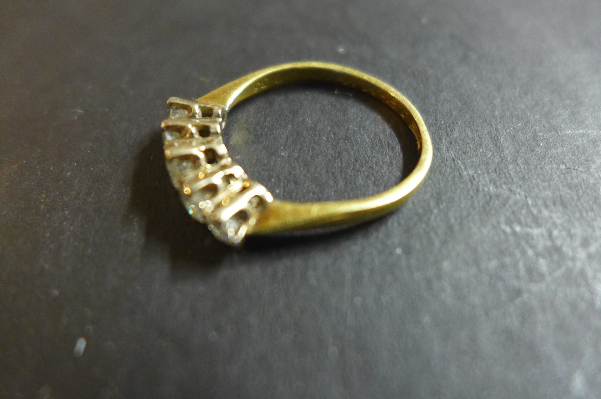 An 18ct gold and diamond ring, set with five graduated stones, the largest central stone approx 0. - Image 3 of 3