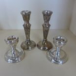 Two pairs of silver candlesticks, tallest 12cm, both generally good, minor dents