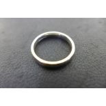 An 18ct white gold wedding band, size O 1/2 - weight approx 4.8 grams, fully hallmarked, surface
