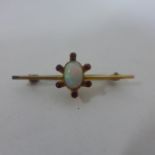 A 9ct yellow gold opal, garnet and ruby brooch, 4cm long, approx 1.8 grams