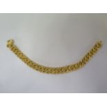 An 18ct gold curb link bracelet, textured finish on one side, weight approx 39.7 grams, length