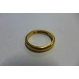 A 22ct yellow gold hallmarked band ring, size U, approx 8.9 grams, some marks consistent with use