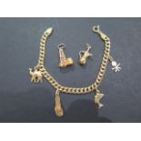 An 18ct gold charm bracelet, stamped 750 - Italian hallmarks - with four charms attached, and two