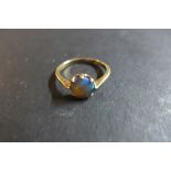 A 9ct rose gold ring, set with a circular opal - ring size N, weight approx 1.7 grams - usage