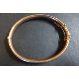 A 9ct rose gold hinged bangle, fully hallmarked, hollow, not filled, weight approx 7.8 grams -