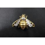 A 14ct yellow and white gold diamond set bee brooch set with seven small diamonds to the wings and