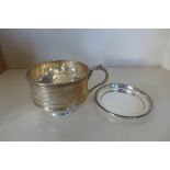 An English silver coaster and a continental silver cup, total weight approx 7.4 troy oz, in