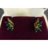 A pair of 14ct yellow gold diamond and emerald earrings, each set with four small diamonds and