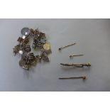 Four stick pins, one with a 15ct gold top and a silver charm bracelet, approx 2.5 troy oz