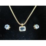 An 18ct gold and aquamarine pendant mounted on a 9ct gold chain with a pair of 9ct gold and