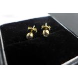 A pair of 9ct gold diamond stud earrings, the collet set diamonds measure approx 0.1cts, 10 points -