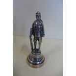 A silver model of a soldier by the Goldsmiths and Silver co, on an ivory base, London hallmark