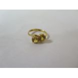 A 22ct and yellow sapphire crossover ring, marked 22K, ring size S, approx 4.9 grams, in a generally