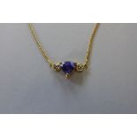 An 18ct gold diamond and tanzanite necklace, the triangular cut tanzanite, approx 5.5mm wide, approx