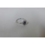 An 18ct white gold sapphire and diamond ring, size L, approx 2.6 grams, head approx 10x8mm - in good