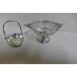 A Walker and Hall pierced silver basket, Birmingham 1897, on a raised foot, and a miniature swing