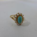 An un hallmarked yellow gold turquoise and pearl ring, size P, approx 2.6 grams, tests to approx 9ct