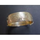 A 9ct rolled gold Victorian style hinged bangle, marked 1/5 9ct rolled gold, weight approx 52.5