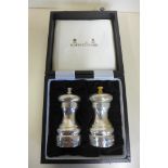 A Mappin and Webb boxed silver salt and pepper set, both with some corrosion 10.5cm tall