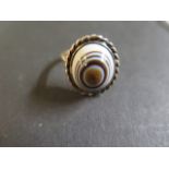 A 9ct gold Sardonyx or Chaledony bulls eye ring, with rope twist, stamped 9ct, ring size M, weight