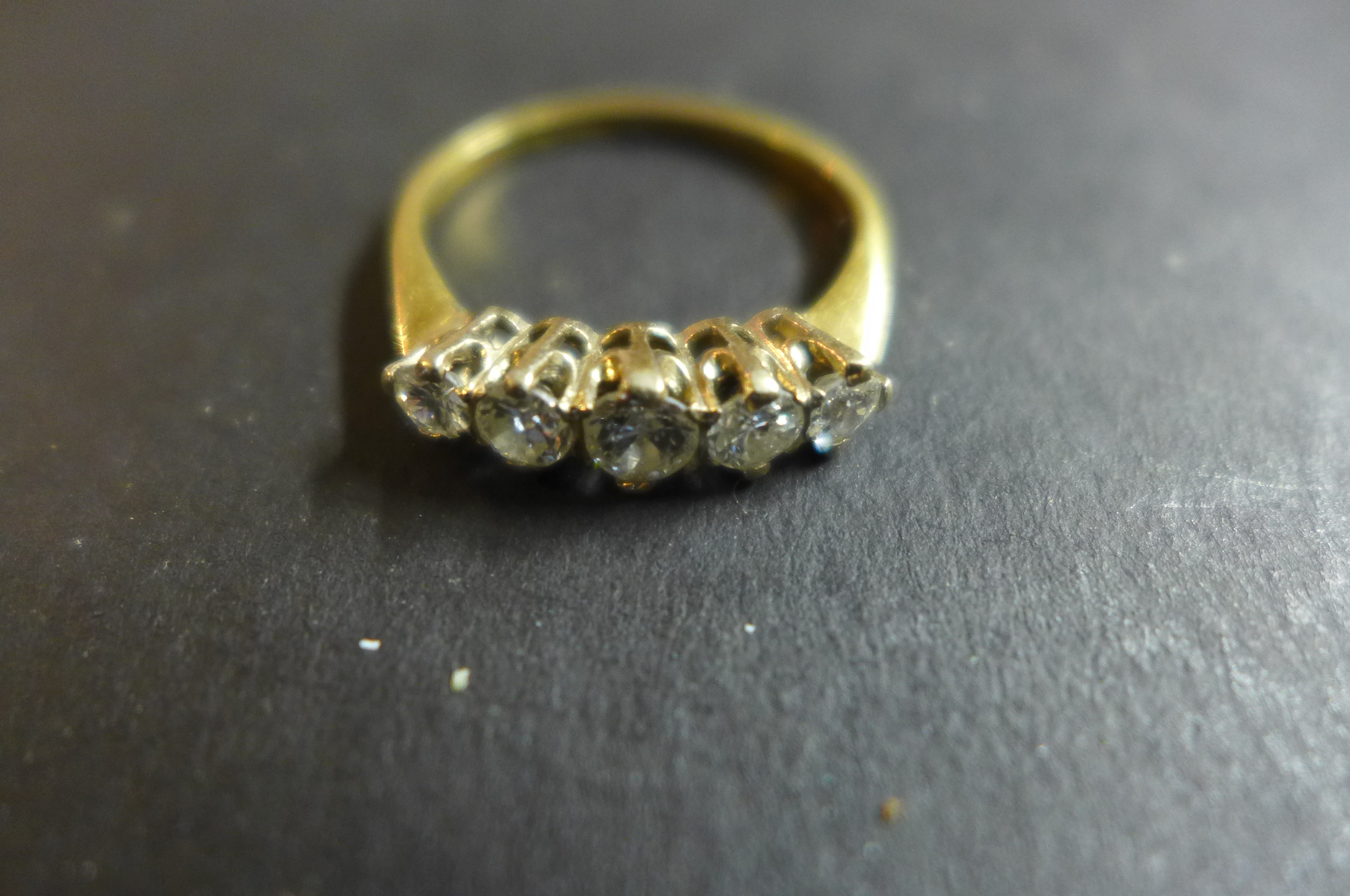 An 18ct gold and diamond ring, set with five graduated stones, the largest central stone approx 0.