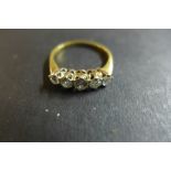 An 18ct gold and diamond ring, set with five graduated stones, the largest central stone approx 0.