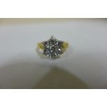 An 18ct gold diamond cluster ring, central stone surrounded by six similar size stones in white gold