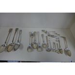 A pair of silver salad servers, a pickle spoon together with 15 silver spoons, and three plated