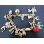 A 14ct gold charm bracelet with fifteen charms, mainly 9ct, total weight approx 49.6 grams, clean