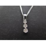 A 9ct white gold diamond necklace pendant set with three small round diamonds in an illusion