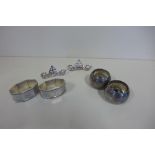 Four silver napkin rings, together with a pair of Edwardian menu holders, weight approx 5.3 troy oz,