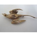 A 9ct gold brooch in the form of a Bermudan Long tail bird with red stone eye, pin stamped 14kt,