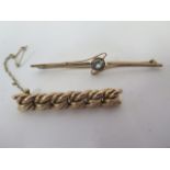 A 15ct bar brooch set with a pale blue stone, length 8cm, weight approx 5.3 grams, stamped 15, and a