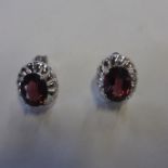 A pair of 9ct white gold pink stone set earrings, approx 4.8 grams, generally good