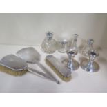 A three piece silver dressing table set, three silver top bottles and a vase and a pair of