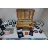 A collection of assorted coinage, banknotes, and costume jewellery in a lockable pine box
