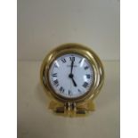 A Cartier gilt travel clock, quartz movement no 0541710 - with folding back, some usage marks, but