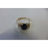 A hallmarked 9ct yellow gold sapphire and diamond ring, sapphire approx 7x5x2.5mm - ring size M,