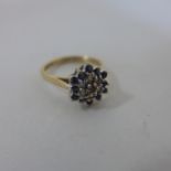 A hallmarked 9ct yellow gold diamond and sapphire cluster ring, size M, approx 2.7 grams,