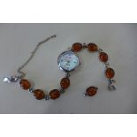 A silver and amber ladies quartz wristwatch with an extra link, 19cm long