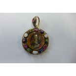 A very pretty gold ruby and opal enameled pendant locket with a well painted miniature of a lady,